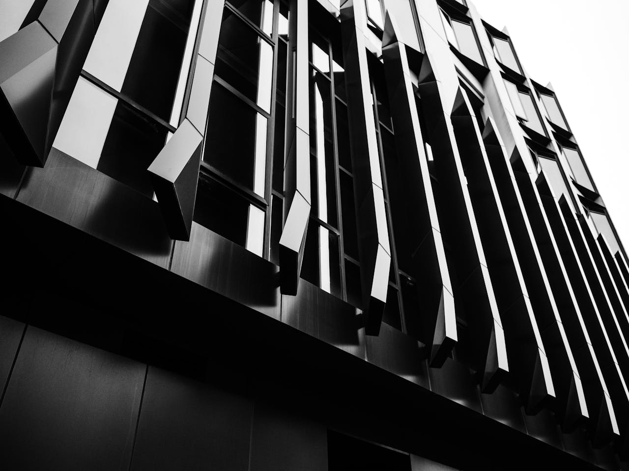 Striking black and white image showcasing modern architectural facade with geometric design.